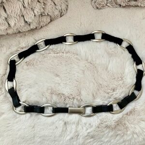 Brushed metal, black leather and stretch women's belt